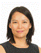 A person with dark hair wearing a black and white striped dress
Description automatically generated